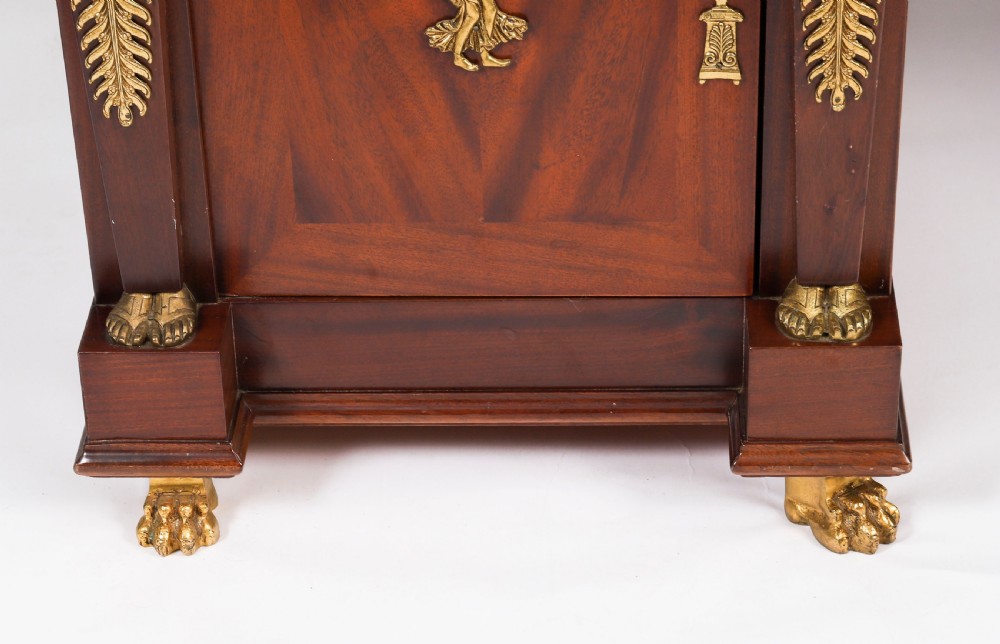 A French Empire style mahogany pedestal desk featuring a green leather top insert, decorative gilt-bronze mounts, and caryatid corner supports. View XV