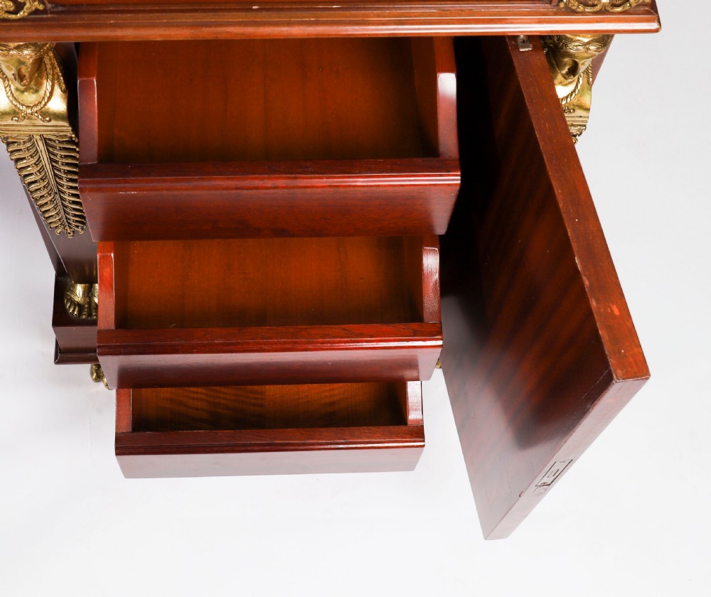 A French Empire style mahogany pedestal desk featuring a green leather top insert, decorative gilt-bronze mounts, and caryatid corner supports. View XVII