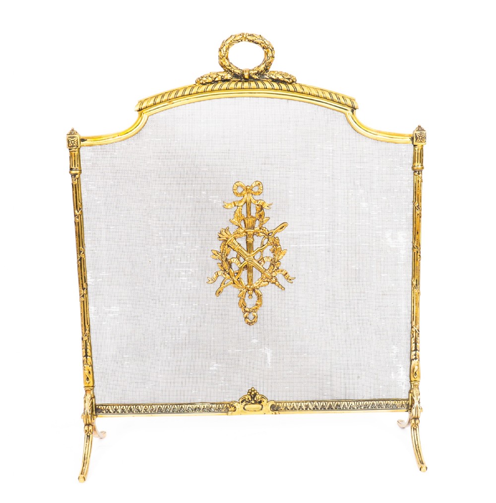 A French Empire Revival gilt bronze fire screen featuring a woven mesh panel, laurel wreath top handle, and central flaming torch motif on splayed feet. View III