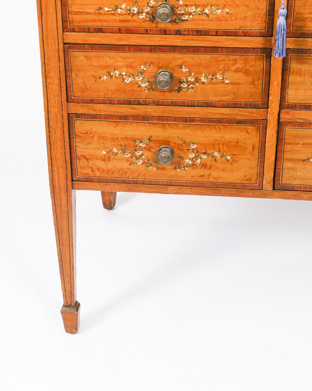 A late Victorian Sheraton Revival satinwood cylinder bureau featuring hand-painted floral swags, a central figural scene, and multiple small drawers above tapered legs. View XI