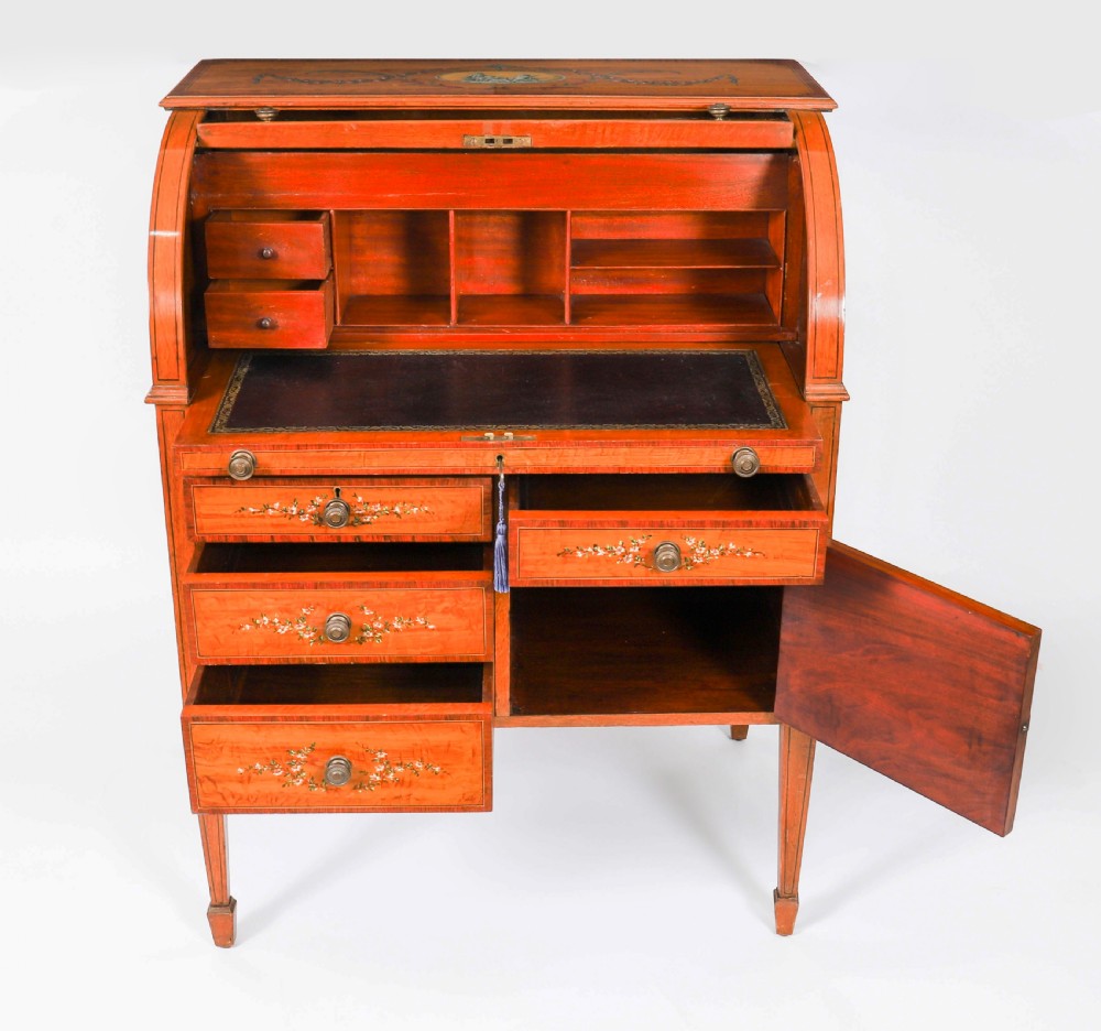 A late Victorian Sheraton Revival satinwood cylinder bureau featuring hand-painted floral swags, a central figural scene, and multiple small drawers above tapered legs. View XIII