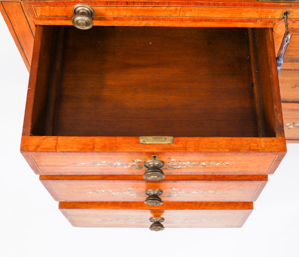 A late Victorian Sheraton Revival satinwood cylinder bureau featuring hand-painted floral swags, a central figural scene, and multiple small drawers above tapered legs. View XVIII