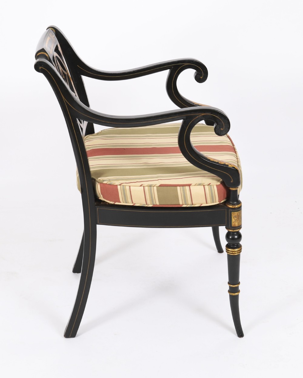 A set of ten ebonised and parcel-gilt Regency Revival dining chairs featuring pierced splat backs and striped upholstered seats. View VIII