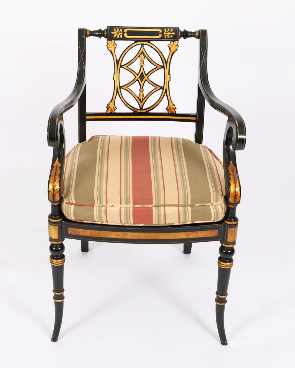 A set of ten ebonised and parcel-gilt Regency Revival dining chairs featuring pierced splat backs and striped upholstered seats. View XI