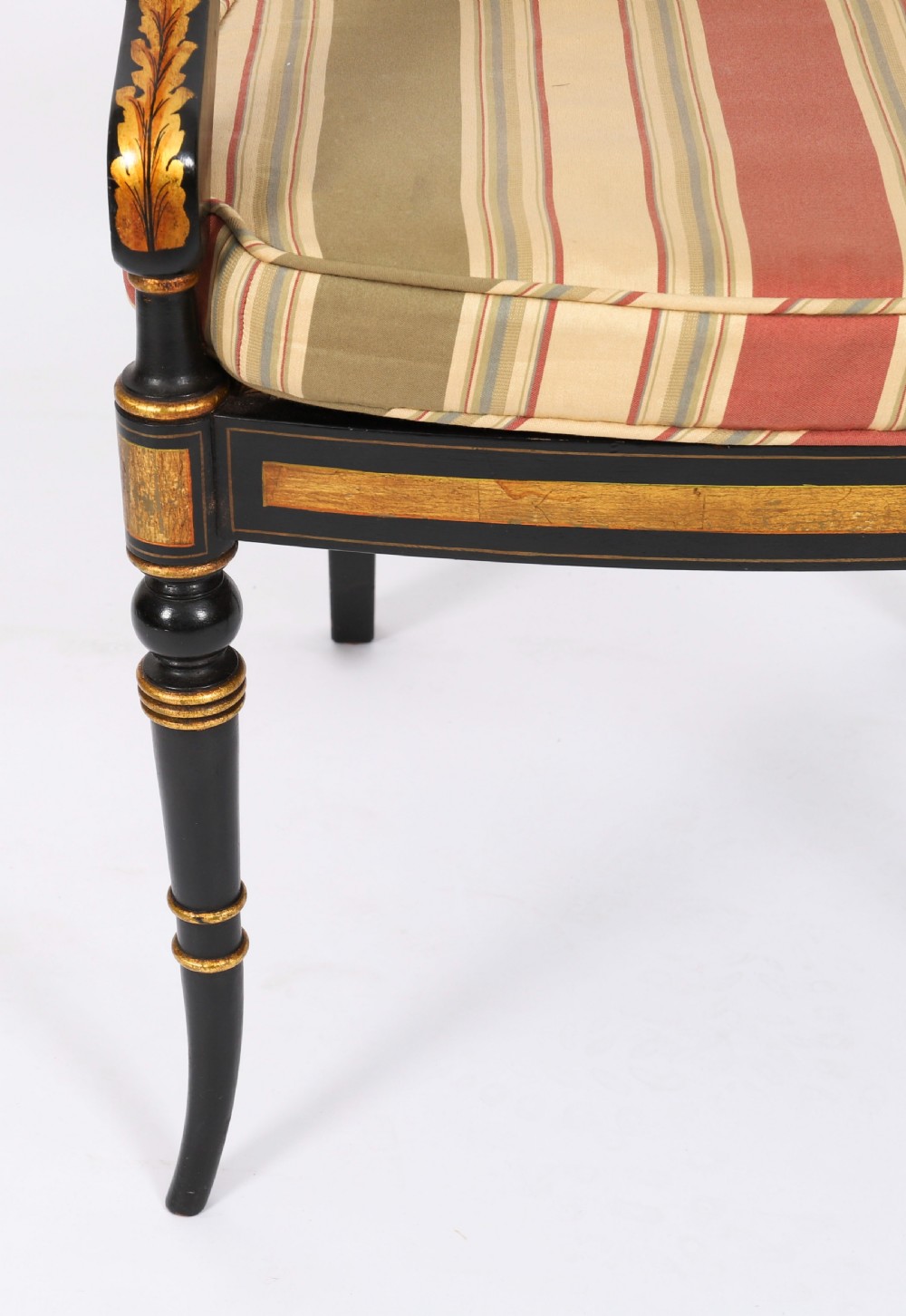 A set of ten ebonised and parcel-gilt Regency Revival dining chairs featuring pierced splat backs and striped upholstered seats. View XIII