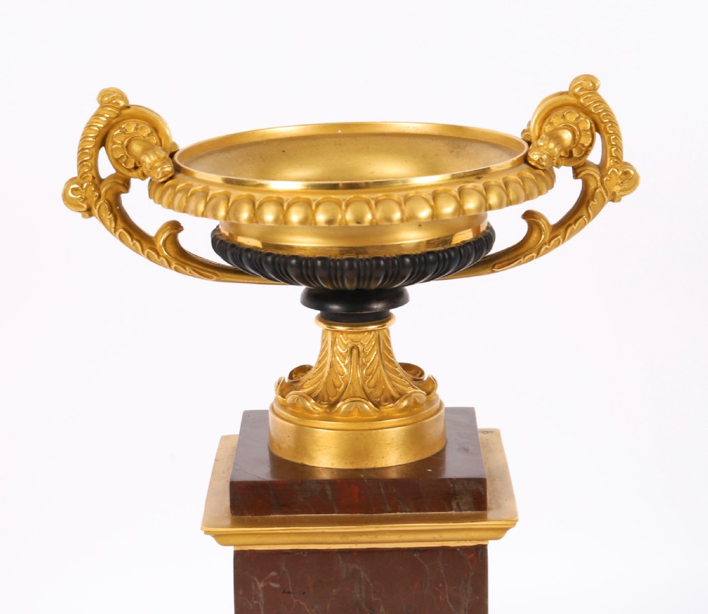 A pair of nineteenth-century French ormolu and bronze tazzas with scroll handles, mounted on tall rectangular red marble plinths. View VI