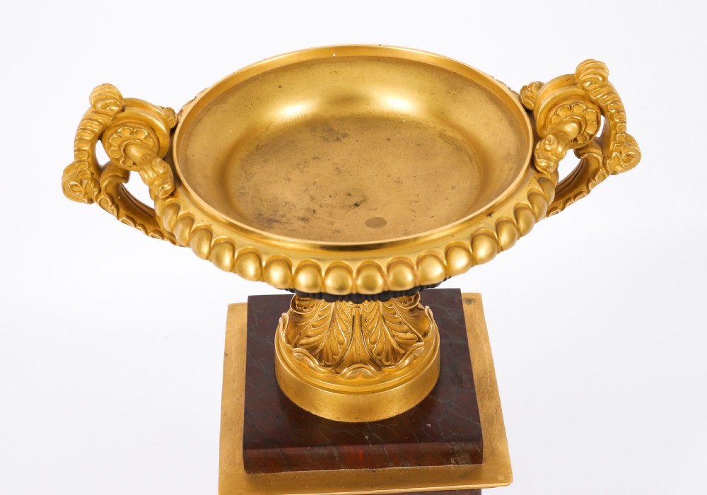 A pair of nineteenth-century French ormolu and bronze tazzas with scroll handles, mounted on tall rectangular red marble plinths. View XI