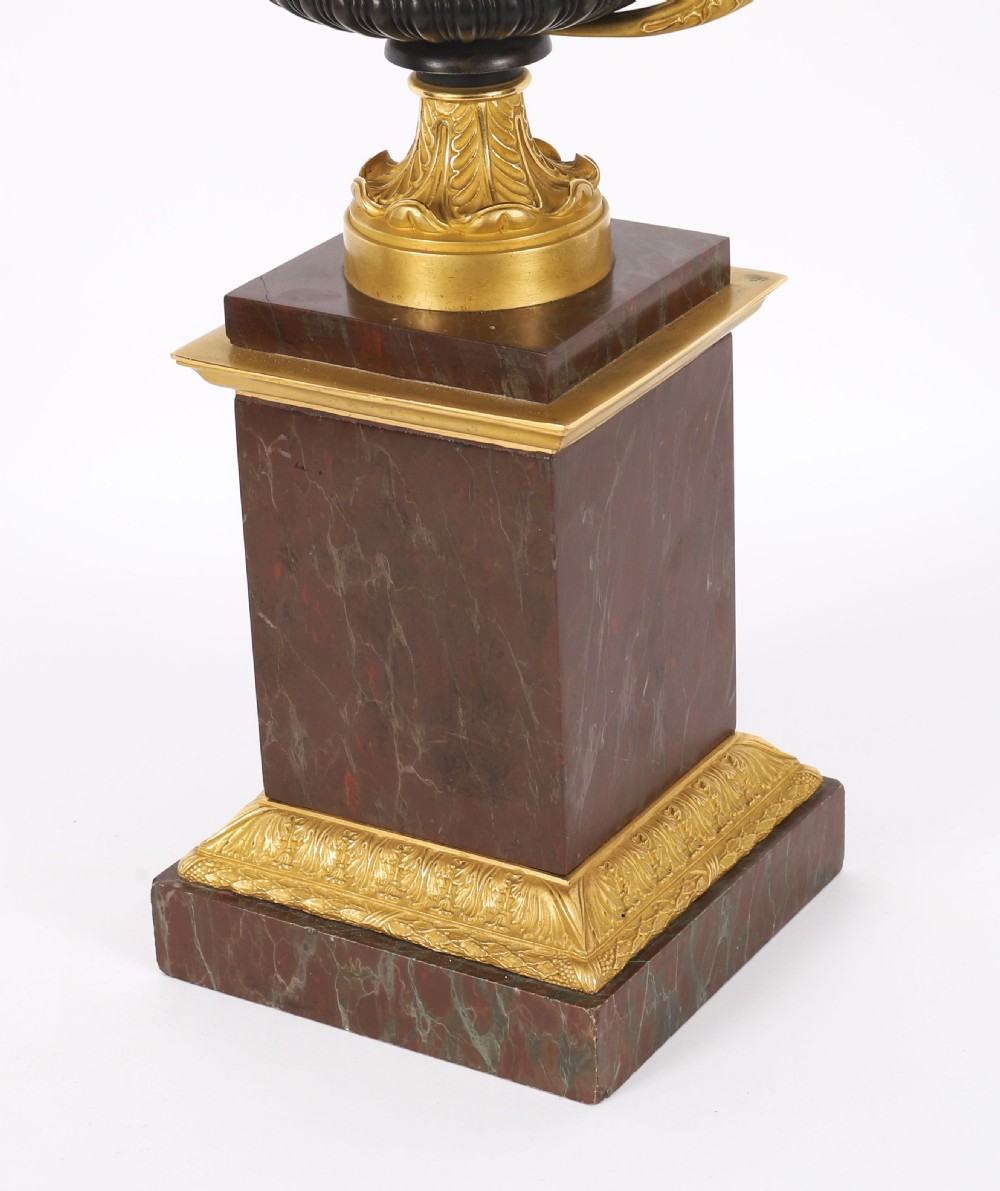 A pair of nineteenth-century French ormolu and bronze tazzas with scroll handles, mounted on tall rectangular red marble plinths. View XIII