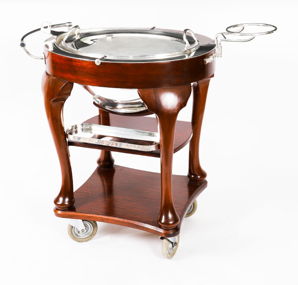 An Art Deco silver-plated beef carving trolley with a hemispherical revolving dome cover mounted on a dark mahogany frame with cabriole legs. View III