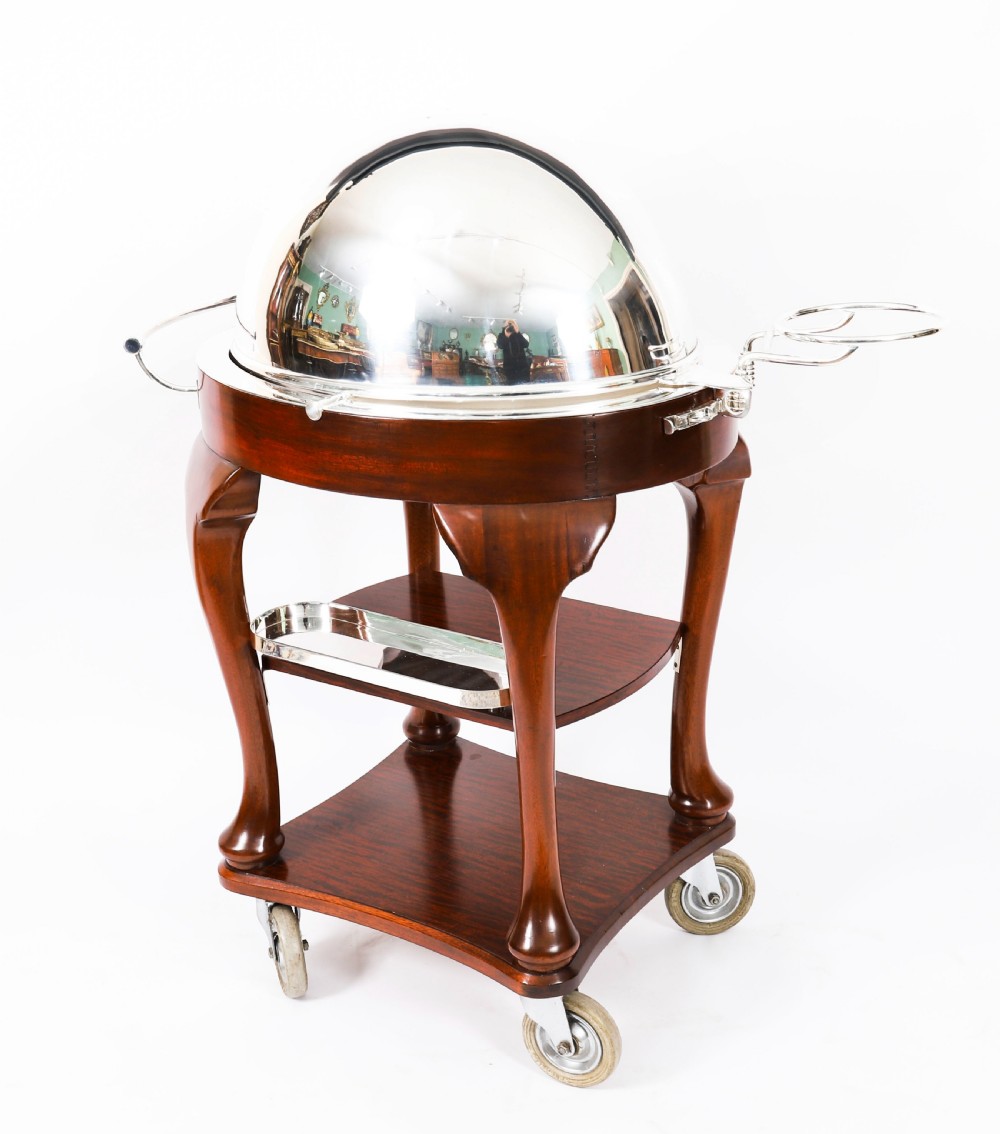 An Art Deco silver-plated beef carving trolley with a hemispherical revolving dome cover mounted on a dark mahogany frame with cabriole legs. View V