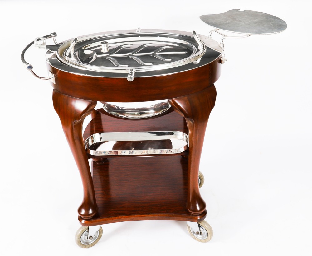 An Art Deco silver-plated beef carving trolley with a hemispherical revolving dome cover mounted on a dark mahogany frame with cabriole legs. View IX