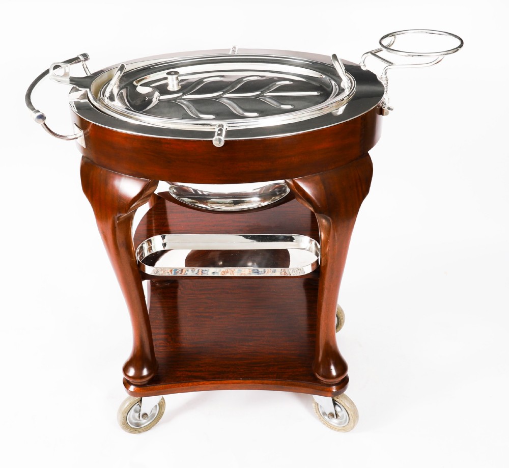 An Art Deco silver-plated beef carving trolley with a hemispherical revolving dome cover mounted on a dark mahogany frame with cabriole legs. View X