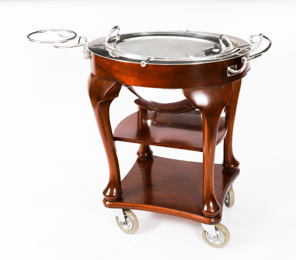 An Art Deco silver-plated beef carving trolley with a hemispherical revolving dome cover mounted on a dark mahogany frame with cabriole legs. View XVI