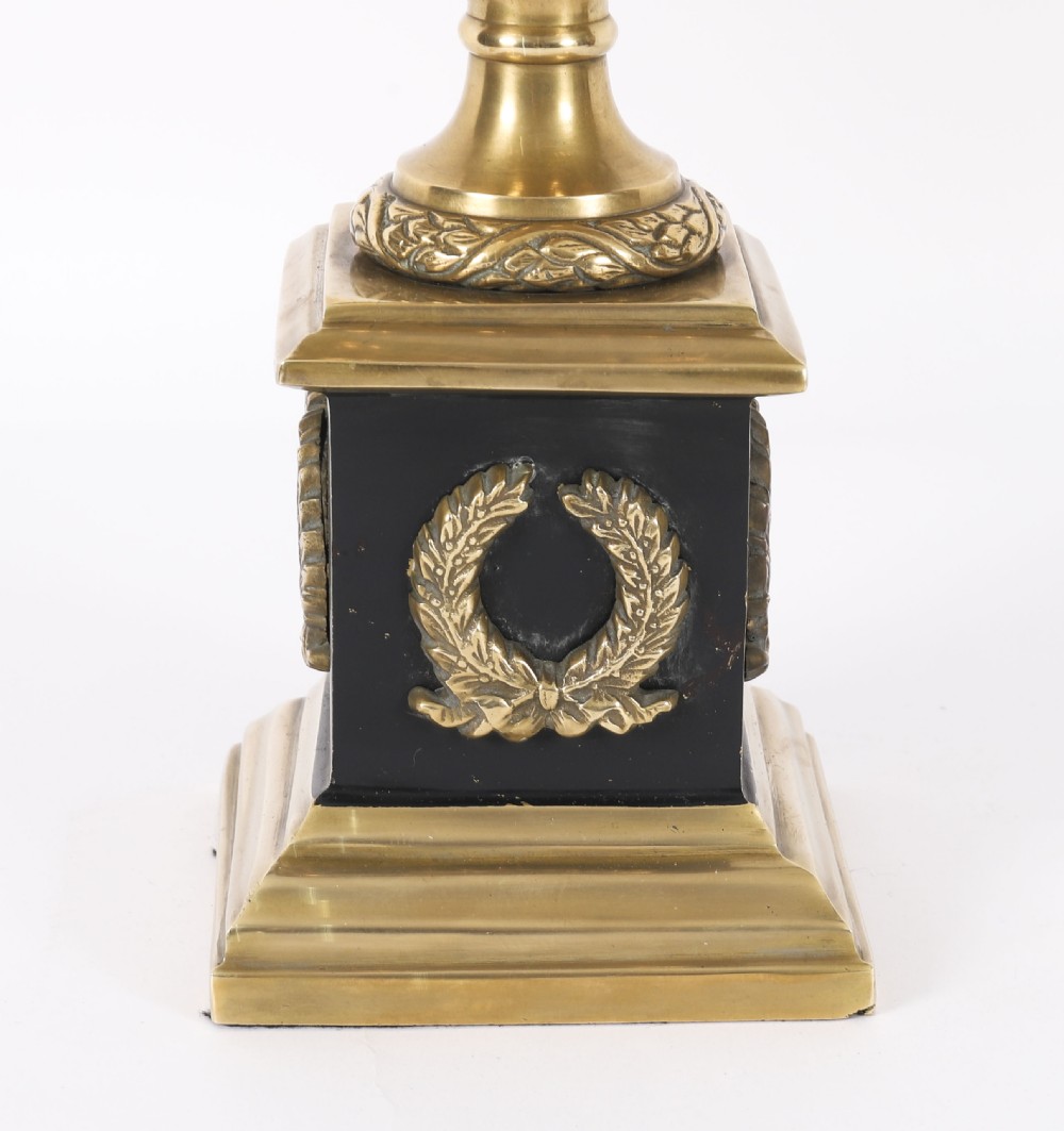 A pair of 19th-century Neoclassical brass Grand Tour campana urns mounted on square black plinths with gilded laurel wreath embellishments. View V