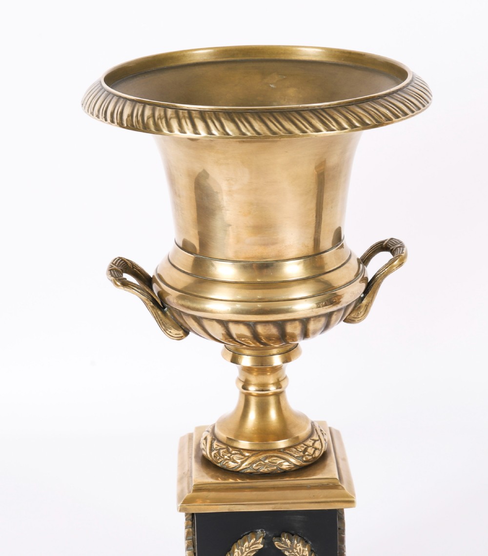 A pair of 19th-century Neoclassical brass Grand Tour campana urns mounted on square black plinths with gilded laurel wreath embellishments. View VII