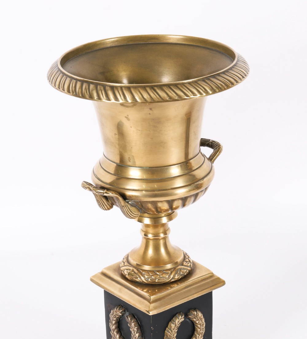 A pair of 19th-century Neoclassical brass Grand Tour campana urns mounted on square black plinths with gilded laurel wreath embellishments. View X