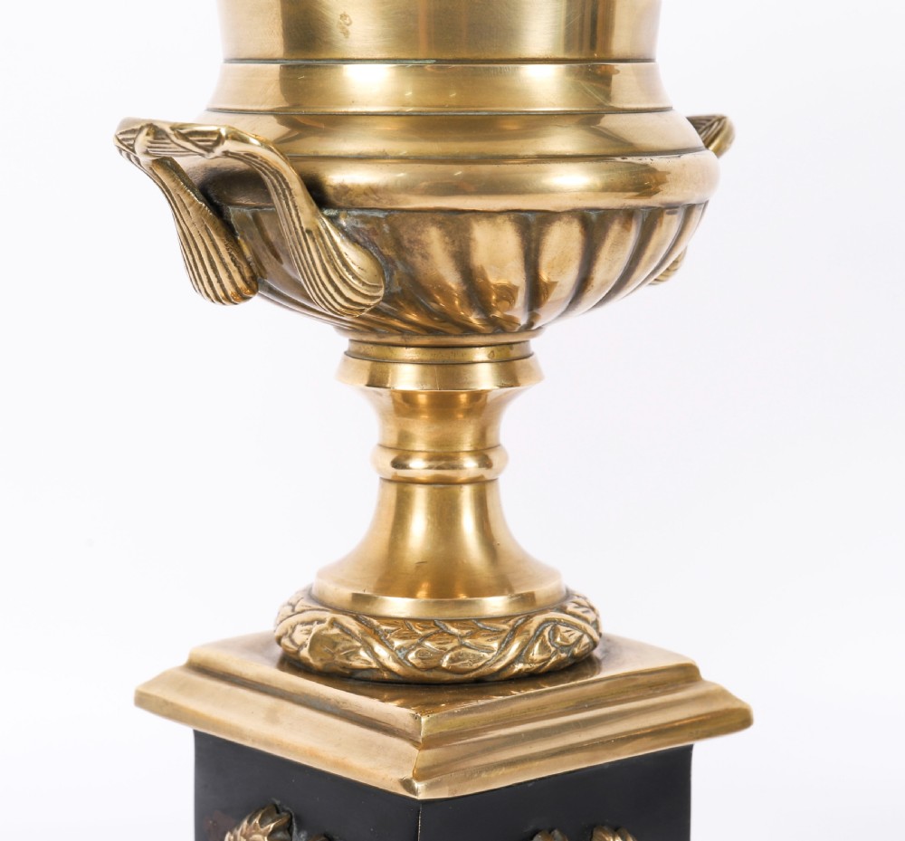 A pair of 19th-century Neoclassical brass Grand Tour campana urns mounted on square black plinths with gilded laurel wreath embellishments. View XII