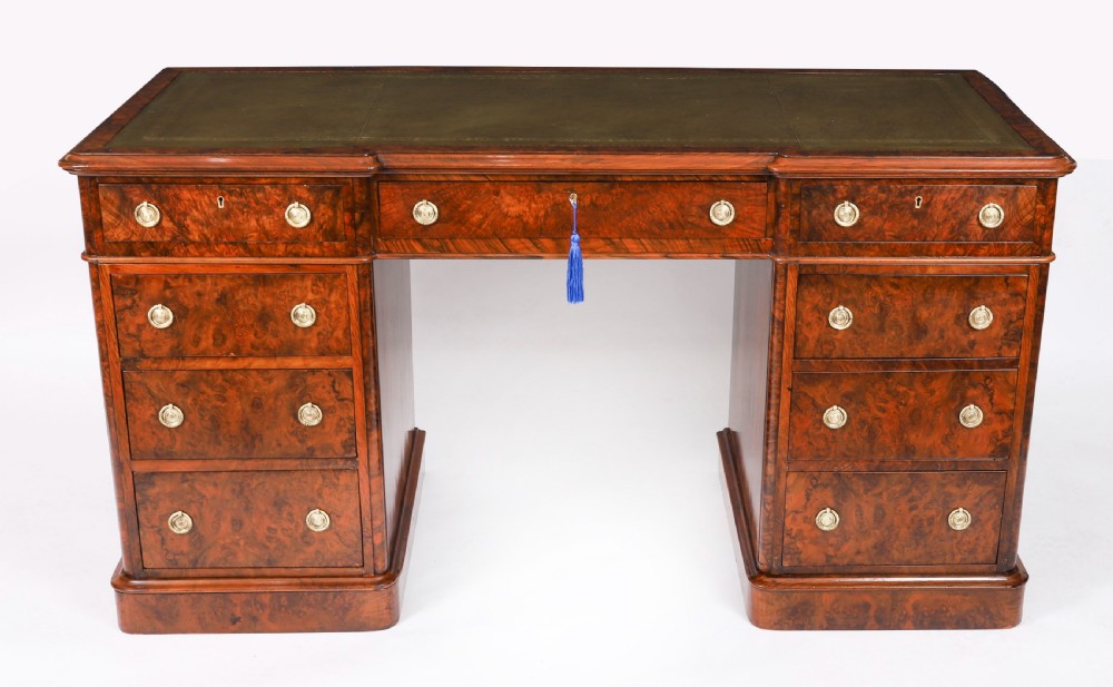 A nineteenth-century Victorian burr walnut twin pedestal desk featuring a green leather writing insert, brass ring handles, and multiple drawers. View II