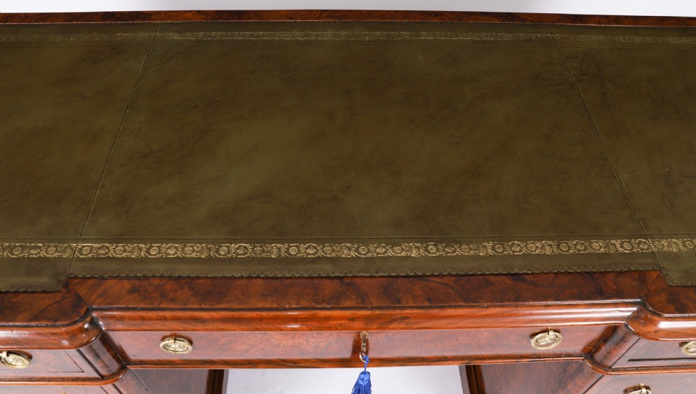 A nineteenth-century Victorian burr walnut twin pedestal desk featuring a green leather writing insert, brass ring handles, and multiple drawers. View III