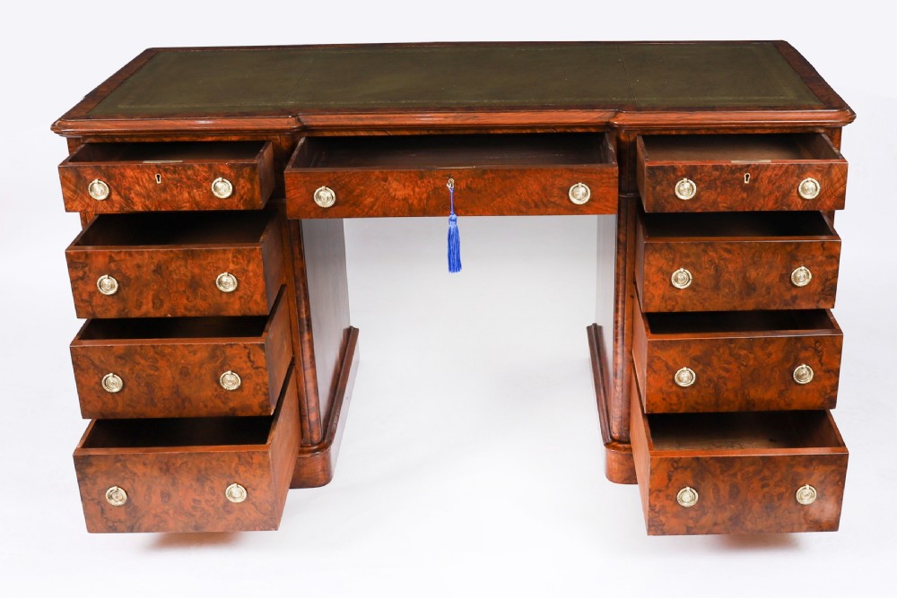 A nineteenth-century Victorian burr walnut twin pedestal desk featuring a green leather writing insert, brass ring handles, and multiple drawers. View VIII