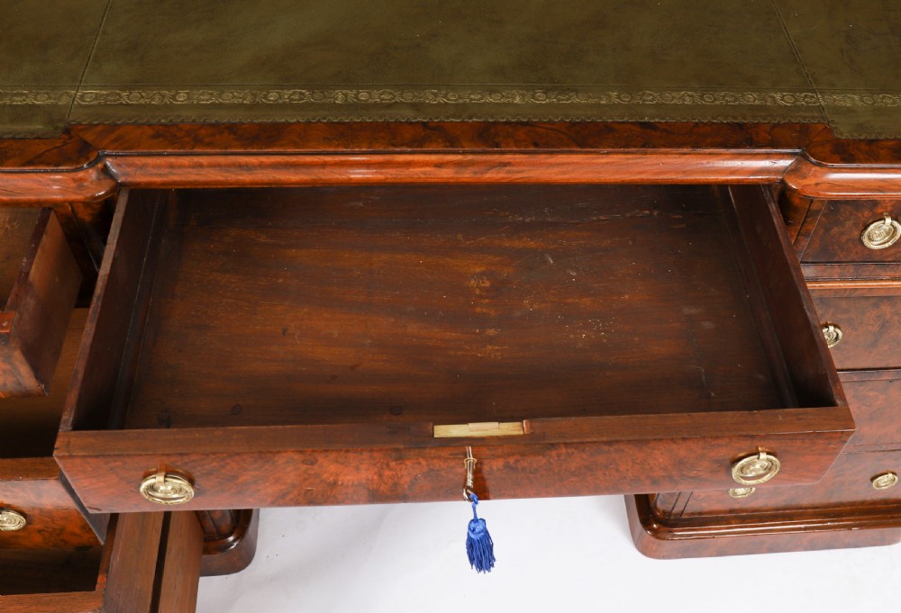 A nineteenth-century Victorian burr walnut twin pedestal desk featuring a green leather writing insert, brass ring handles, and multiple drawers. View XIII