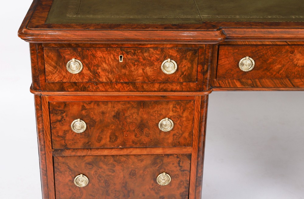 A nineteenth-century Victorian burr walnut twin pedestal desk featuring a green leather writing insert, brass ring handles, and multiple drawers. View XIV