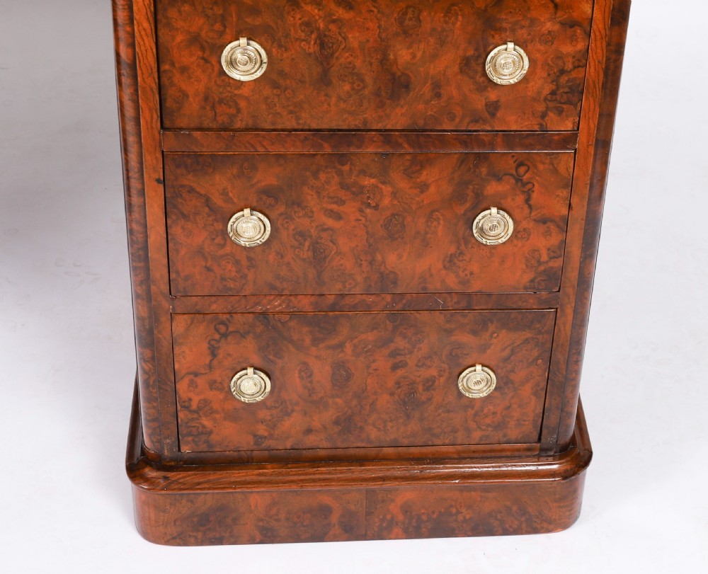 A nineteenth-century Victorian burr walnut twin pedestal desk featuring a green leather writing insert, brass ring handles, and multiple drawers. View XVII