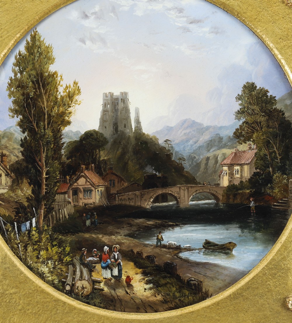 A pair of nineteenth-century oil paintings on board depicting river scenes with figures and ruins, housed in square gilded frames with circular tondo apertures. View VII