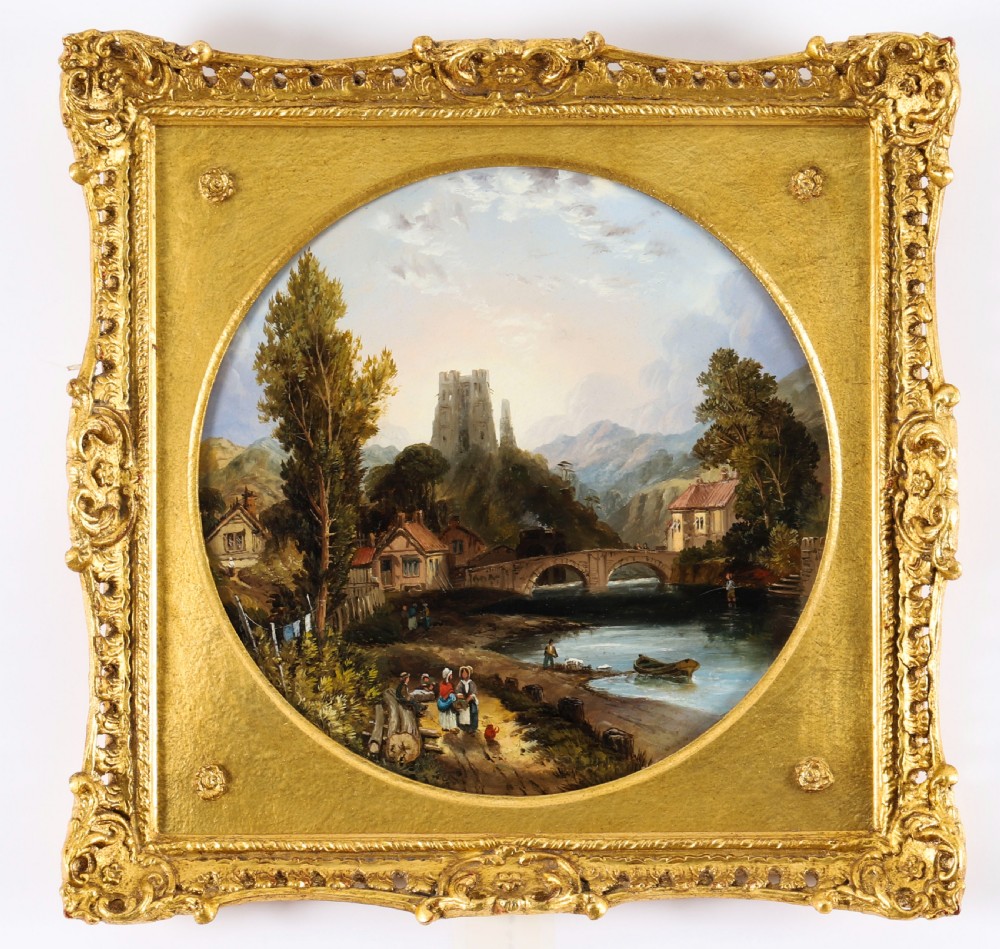 A pair of nineteenth-century oil paintings on board depicting river scenes with figures and ruins, housed in square gilded frames with circular tondo apertures. View X