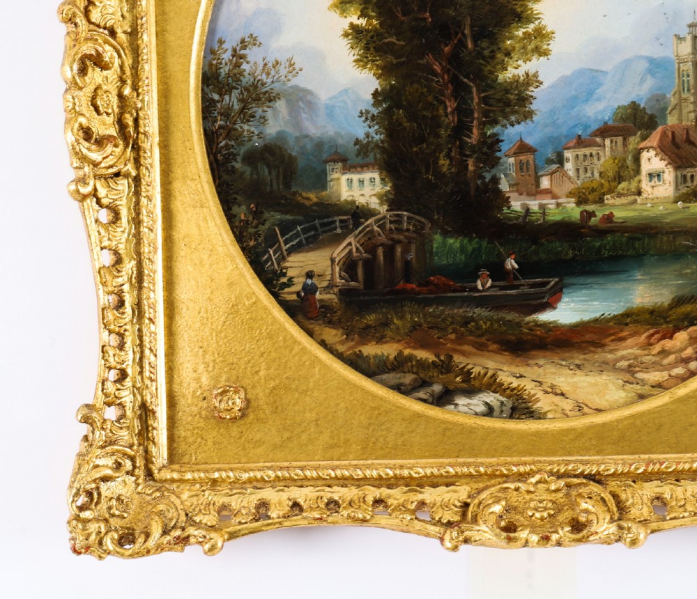 A pair of nineteenth-century oil paintings on board depicting river scenes with figures and ruins, housed in square gilded frames with circular tondo apertures. View XVIII