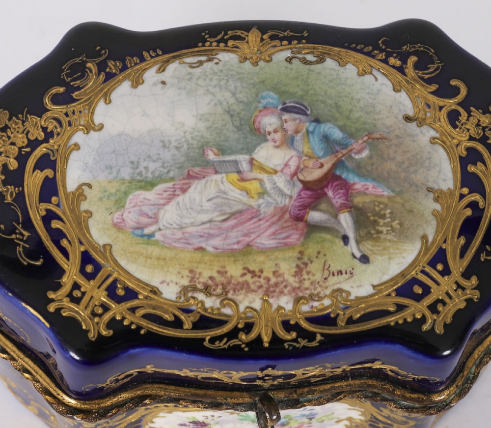 A serpentine cobalt blue porcelain casket featuring gilt-bronze mounts, hand-painted romantic scenes, floral reserves, and heavy gold scrollwork. View IV