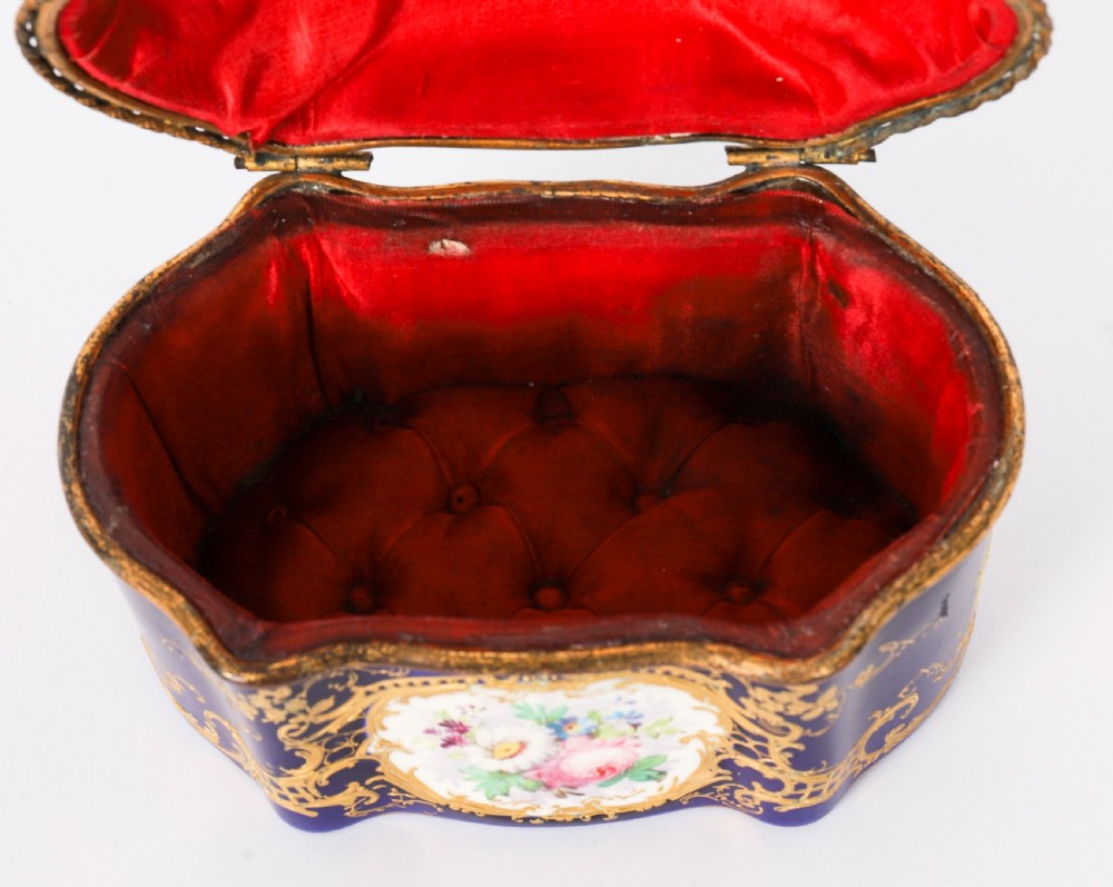 A serpentine cobalt blue porcelain casket featuring gilt-bronze mounts, hand-painted romantic scenes, floral reserves, and heavy gold scrollwork. View IX