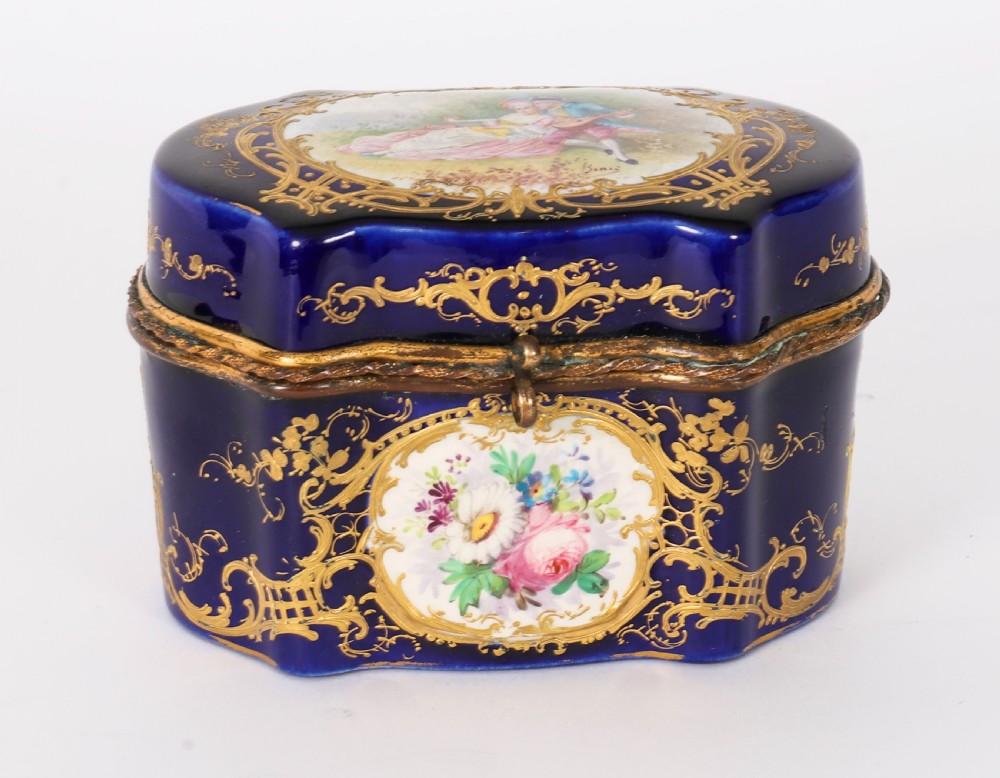 A serpentine cobalt blue porcelain casket featuring gilt-bronze mounts, hand-painted romantic scenes, floral reserves, and heavy gold scrollwork. View XIV