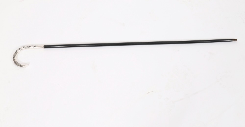A 19th-century walking cane featuring a curved silver crook handle embossed with cherry blossom motifs attached to a dark wood shaft. View II