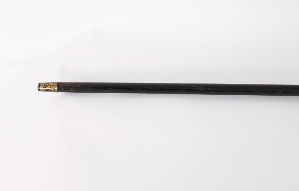 Late 19th-century walking stick featuring a carved spiral horn pommel above an engraved 18ct gold band on a dark wood shaft. View VI