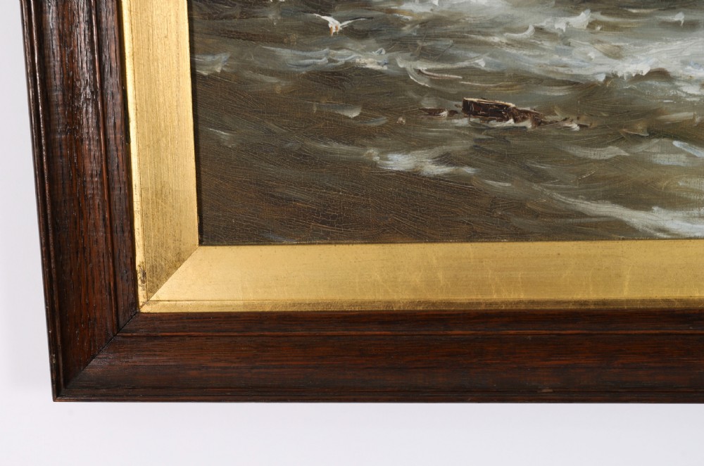 A pair of framed 19th-century oil on canvas paintings depicting coastal seascapes with wooden fishing vessels, encased in dark wood frames with gilded inner slips. View VII