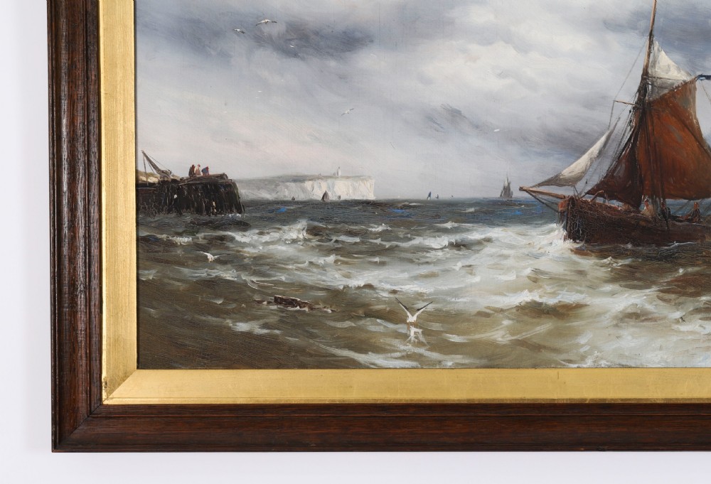 A pair of framed 19th-century oil on canvas paintings depicting coastal seascapes with wooden fishing vessels, encased in dark wood frames with gilded inner slips. View VIII