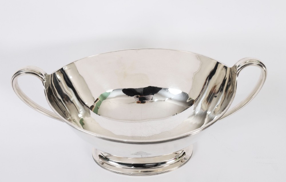 A George III sterling silver tureen with two looped handles, a domed lid, a pedestal base, and an engraved heraldic crest. View XIII