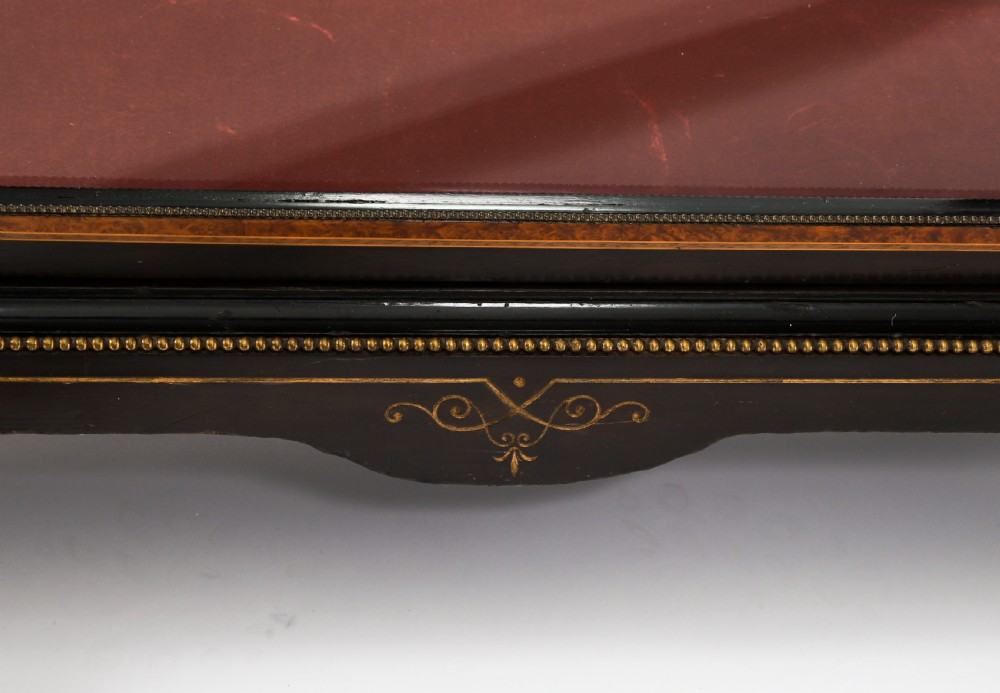 A Victorian ebonised and amboyna wood pier display cabinet featuring glass doors, interior glass shelves, and gilded brass mounts. View VII