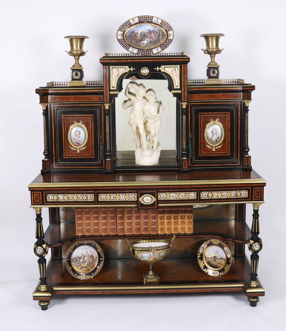 Victorian amboyna and ebonised bonheur du jour desk with porcelain portrait plaques, brass mounts, a central mirror, and an open lower shelf. View II