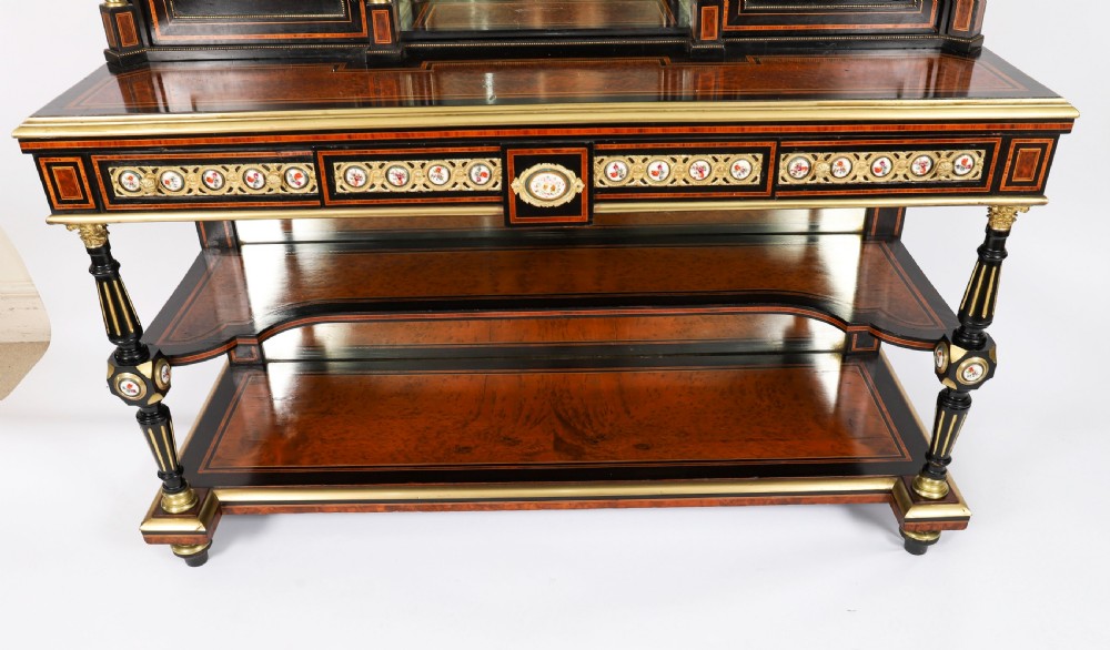 Victorian amboyna and ebonised bonheur du jour desk with porcelain portrait plaques, brass mounts, a central mirror, and an open lower shelf. View VII