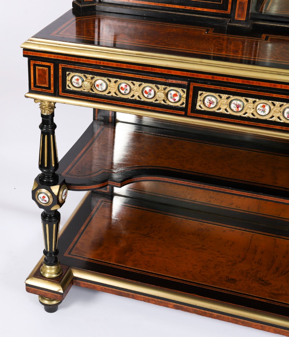 Victorian amboyna and ebonised bonheur du jour desk with porcelain portrait plaques, brass mounts, a central mirror, and an open lower shelf. View VIII