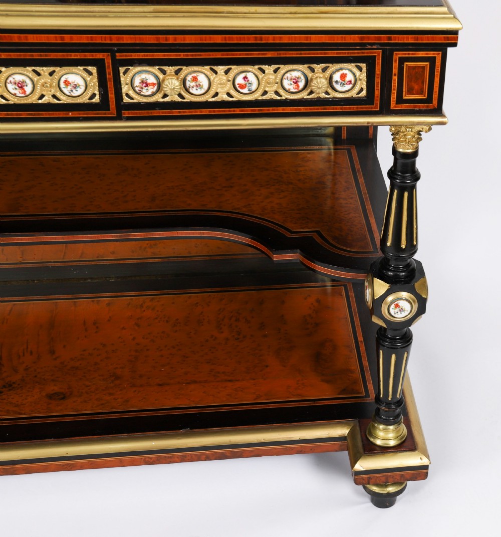 Victorian amboyna and ebonised bonheur du jour desk with porcelain portrait plaques, brass mounts, a central mirror, and an open lower shelf. View IX