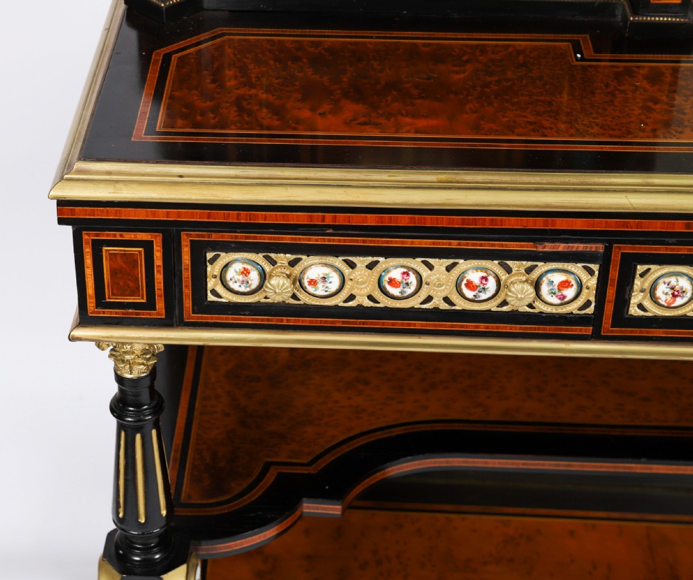 Victorian amboyna and ebonised bonheur du jour desk with porcelain portrait plaques, brass mounts, a central mirror, and an open lower shelf. View XI