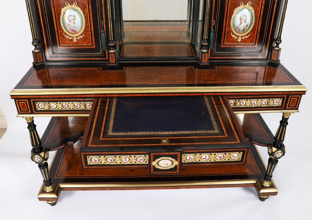 Victorian amboyna and ebonised bonheur du jour desk with porcelain portrait plaques, brass mounts, a central mirror, and an open lower shelf. View XIII