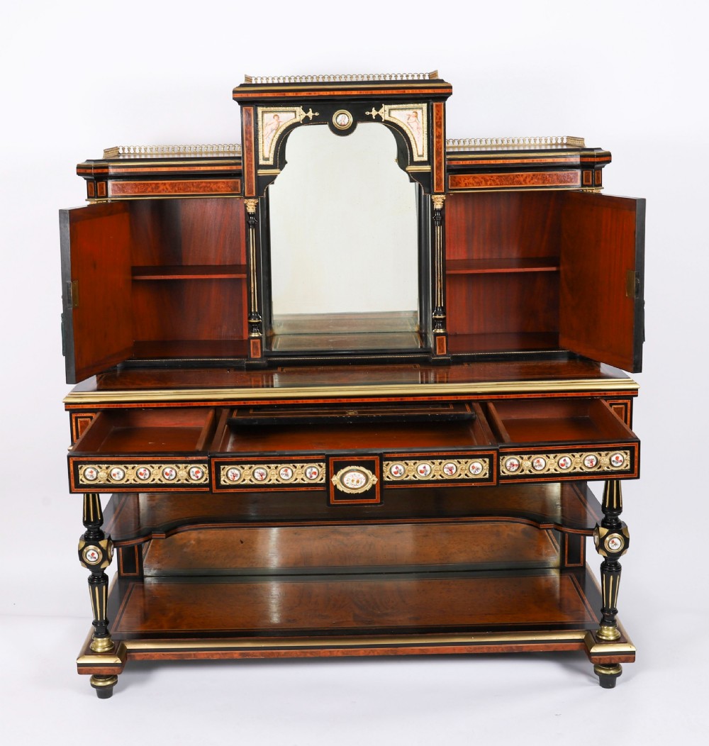 Victorian amboyna and ebonised bonheur du jour desk with porcelain portrait plaques, brass mounts, a central mirror, and an open lower shelf. View XV