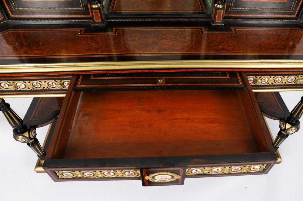 Victorian amboyna and ebonised bonheur du jour desk with porcelain portrait plaques, brass mounts, a central mirror, and an open lower shelf. View XVI