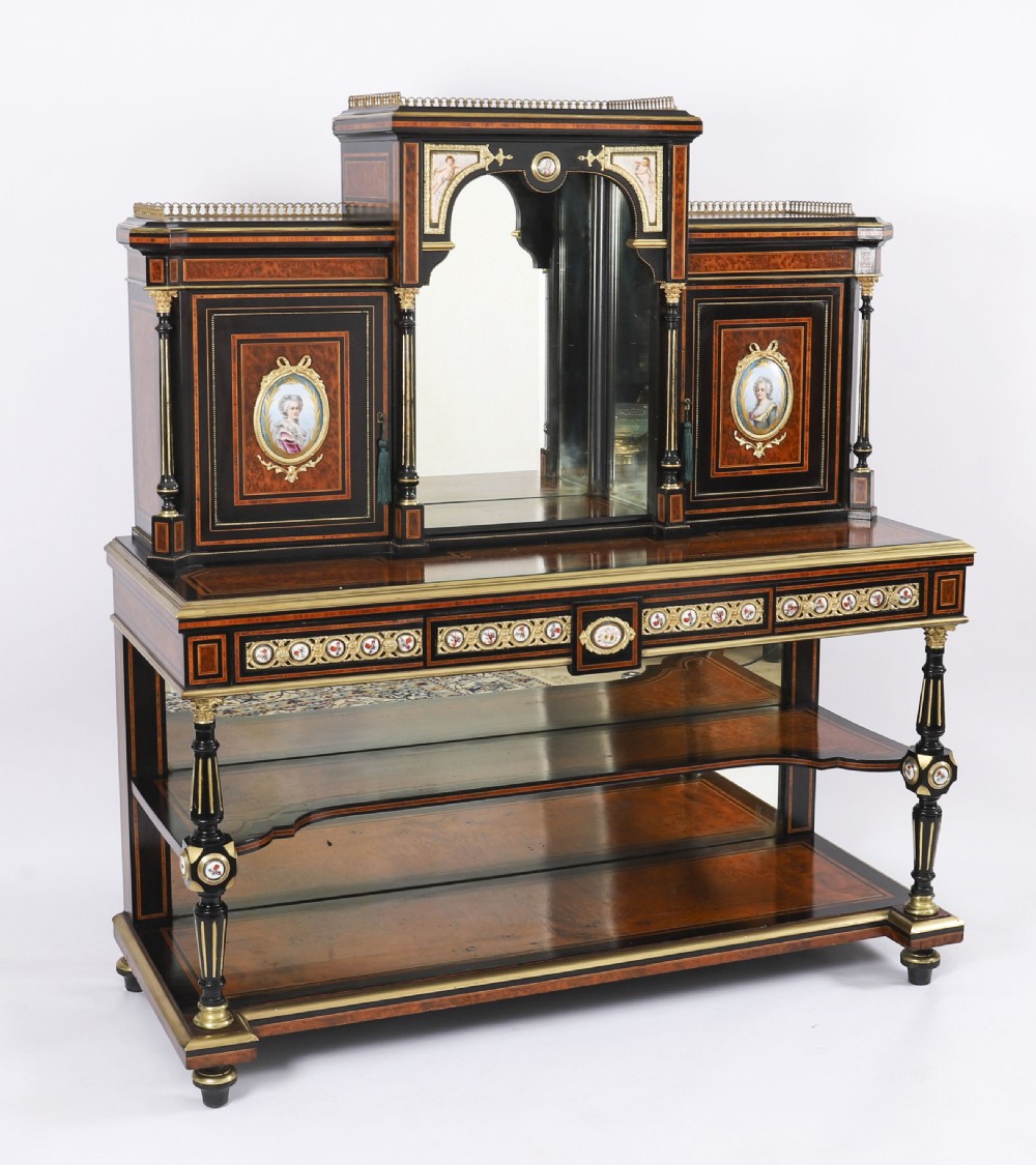 Victorian amboyna and ebonised bonheur du jour desk with porcelain portrait plaques, brass mounts, a central mirror, and an open lower shelf. View XX