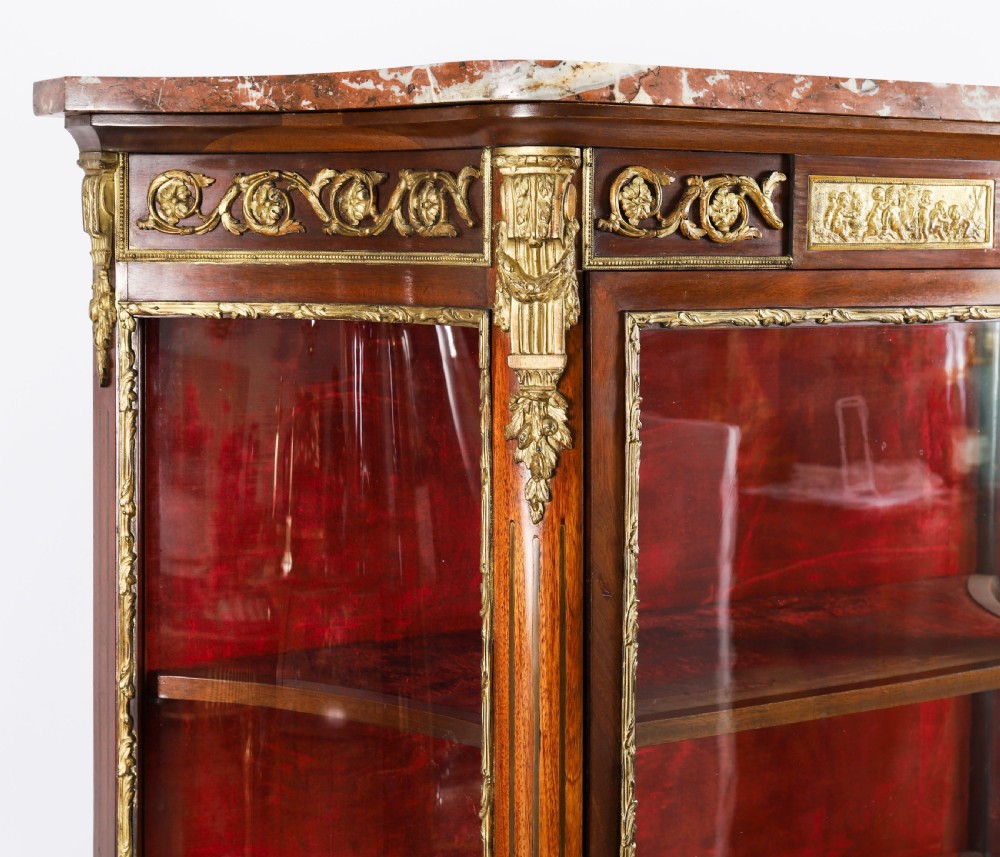 A 19th-century French Louis Revival vitrine cabinet featuring a marble top, glazed glass sides and door, floral marquetry panels, and ornate gilt bronze mounts. View X