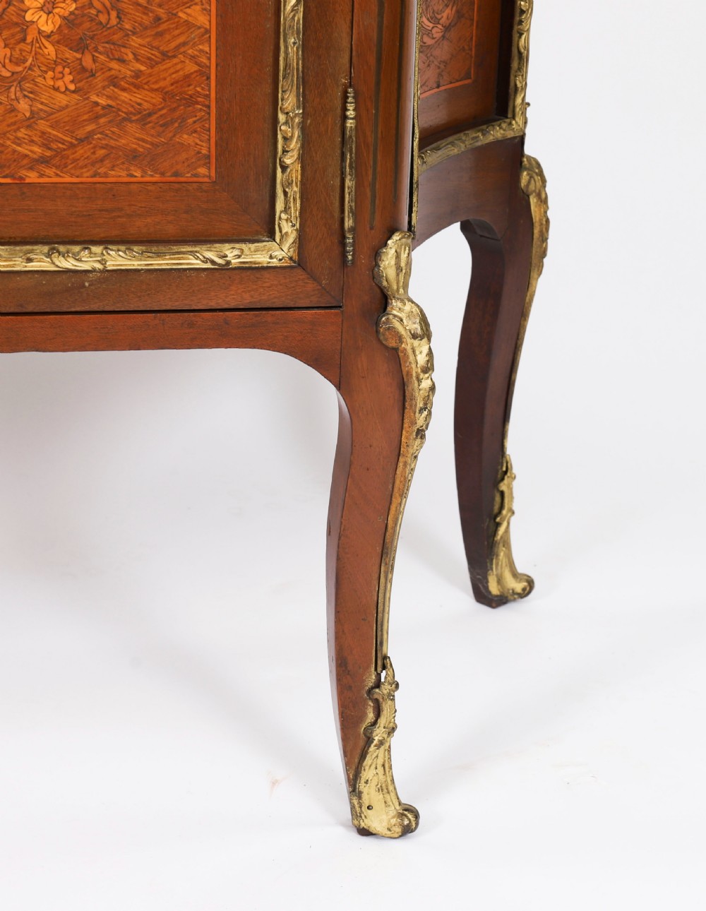 A 19th-century French Louis Revival vitrine cabinet featuring a marble top, glazed glass sides and door, floral marquetry panels, and ornate gilt bronze mounts. View XVI